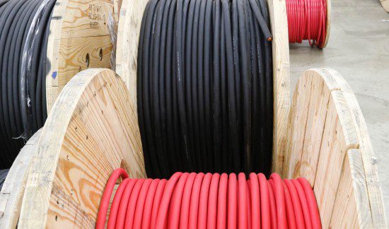 a large pile of red and black electrical wires, which are arranged in a circular fashion