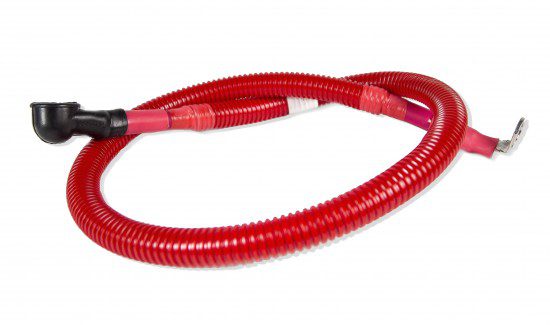 a red hose, possibly a fire hose, lying on a white surface